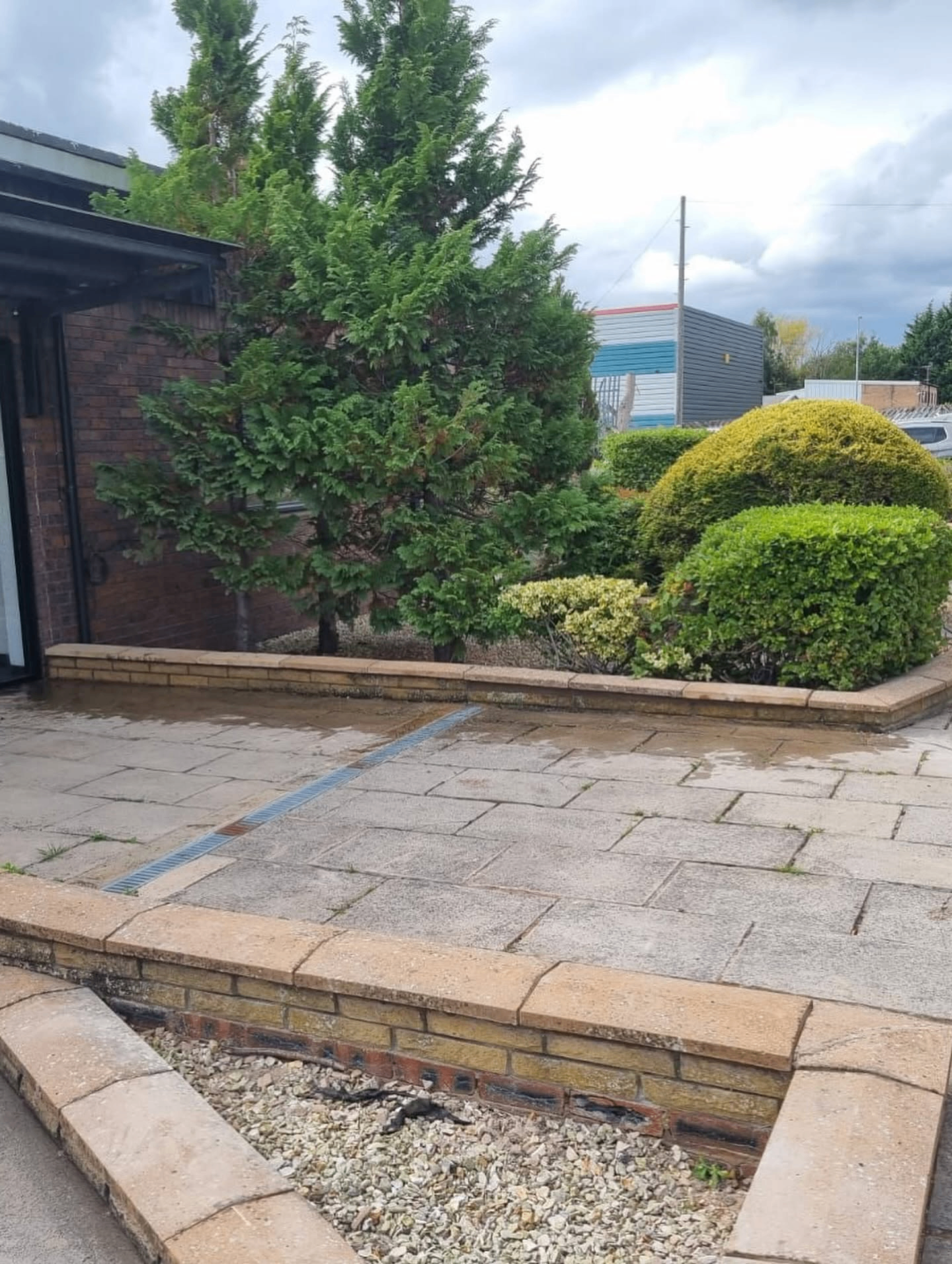 Freshly planted shrubs and seasonal flowering bedding in a tidy mulched bed