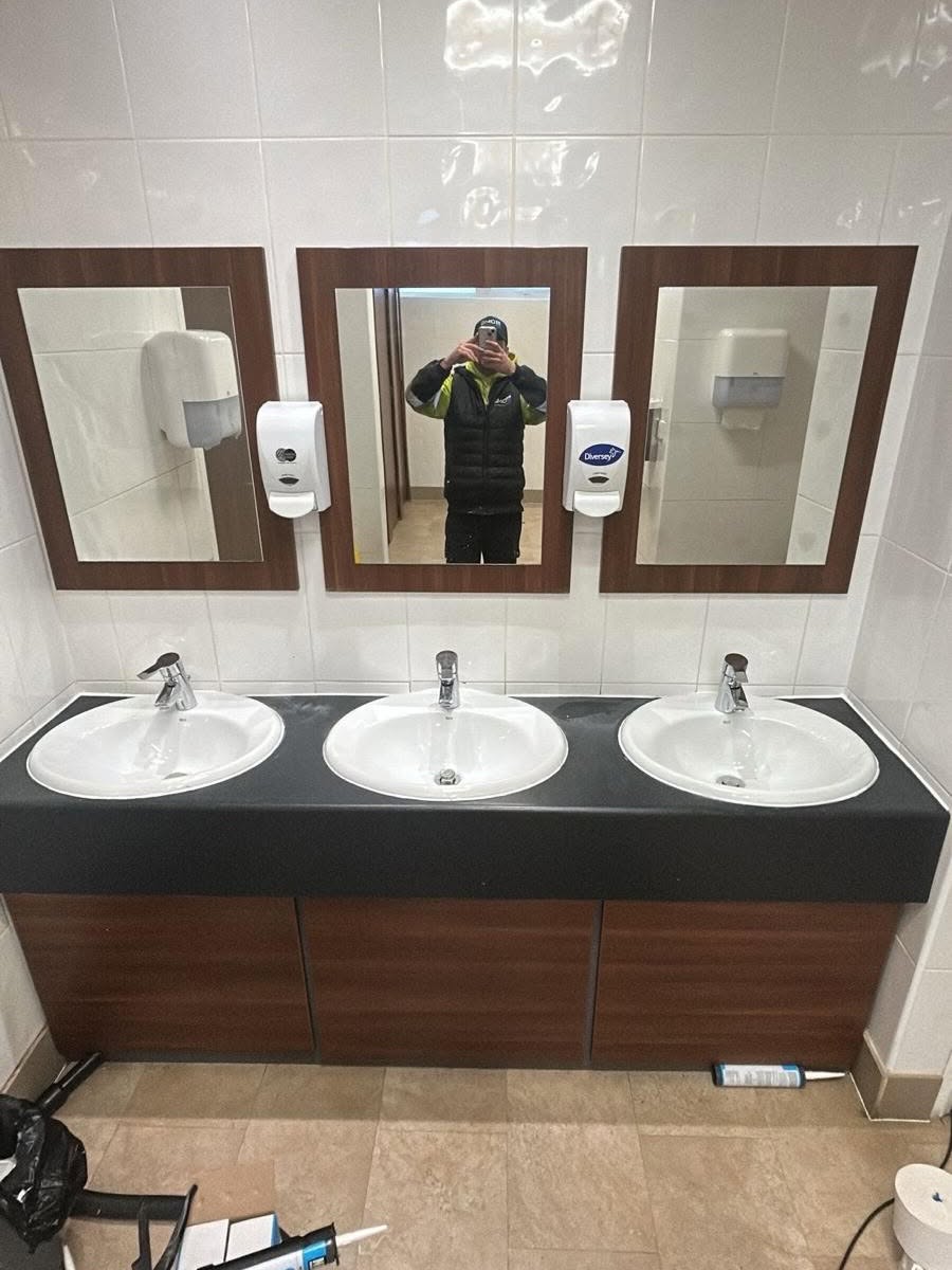 Three new vanity sinks plumbed in beneath fitted mirrors