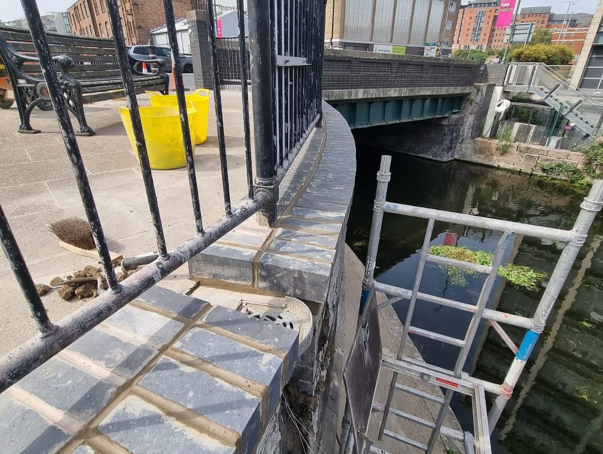 Brickwork and pointing repaired on a public walkway bridge wall