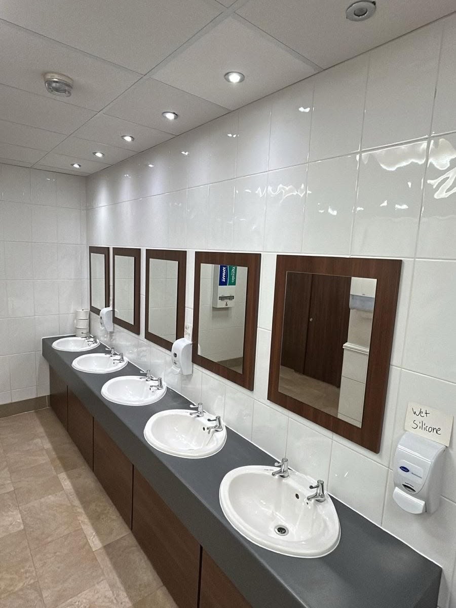 Row of newly fitted commercial sinks and taps after a plumbing install